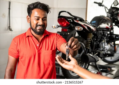 smiling motorbike mechanic giving motobike 260nw 2136515267